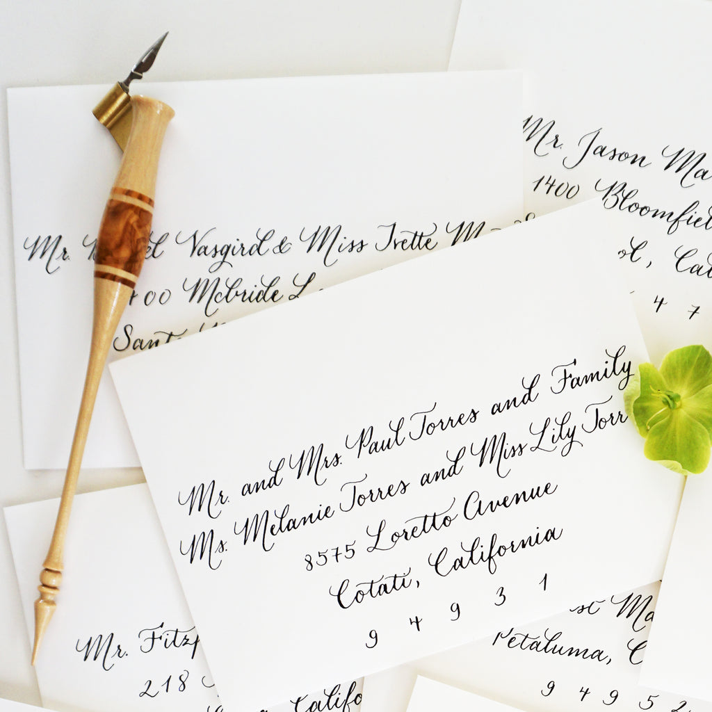 quill with calligraphy on envelopes